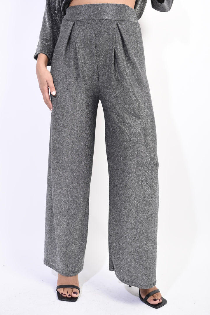 Wide Leg Trouser: A person wearing grey wide-leg trousers, showcasing their comfortable and versatile design, ideal for both casual and formal occasions.