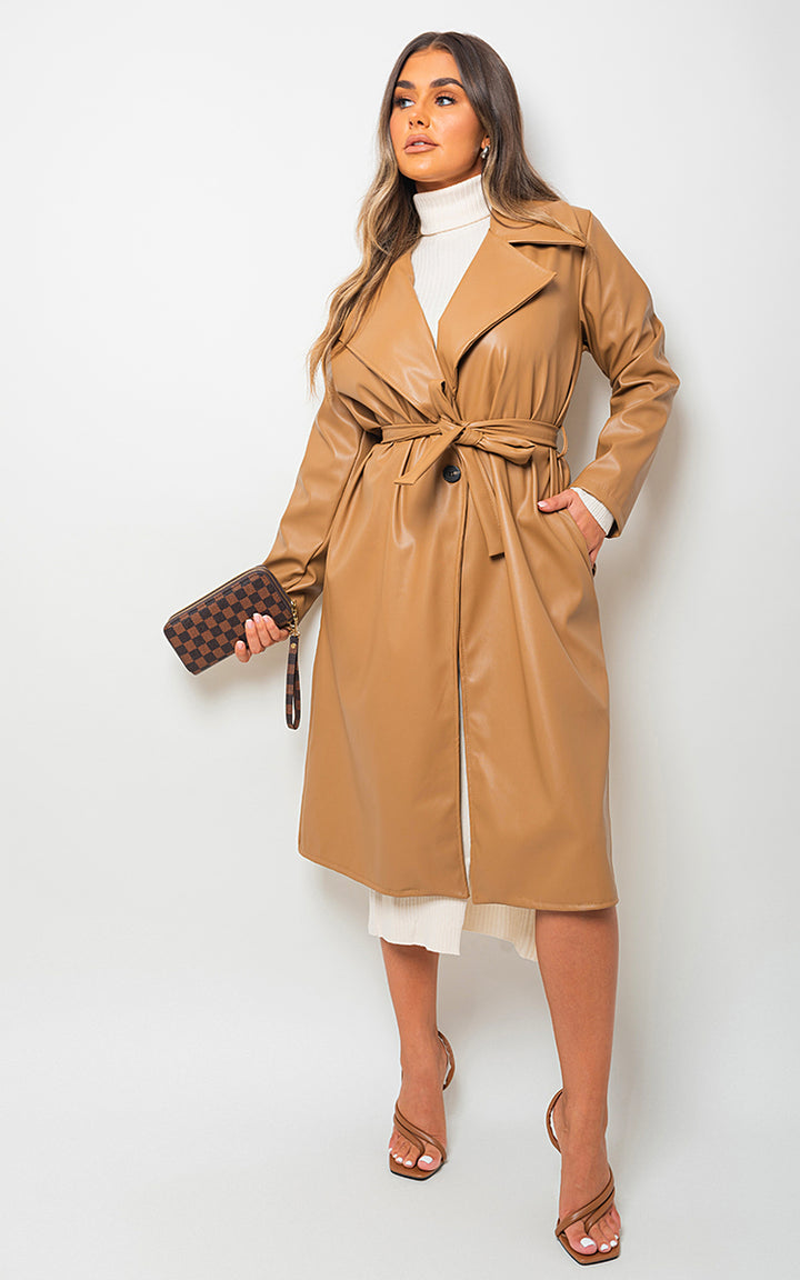 Meredith Longline Belted Trench Coat on woman, showcasing elegant, timeless style with a checkered wallet, emphasizing sophisticated versatility for everyday wear.