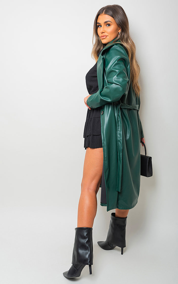 Woman modeling the Meredith Longline Belted Trench Coat, showcasing its elegant silhouette and belted design, emphasizing sophistication and versatility.