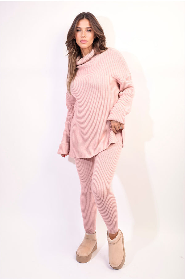 Chunky Knitted High Roll Neck Top Bottom Co-ord Set worn by woman, showcasing cozy, stylish design with matching sweater and pants, perfect for winter fashion.