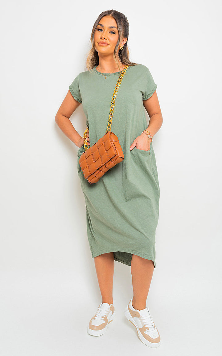 Woman in a Front Pockets Short Sleeve Midi Dress, holding a brown purse, paired with white and tan sneakers. Ideal for versatile, stylish holiday wear.