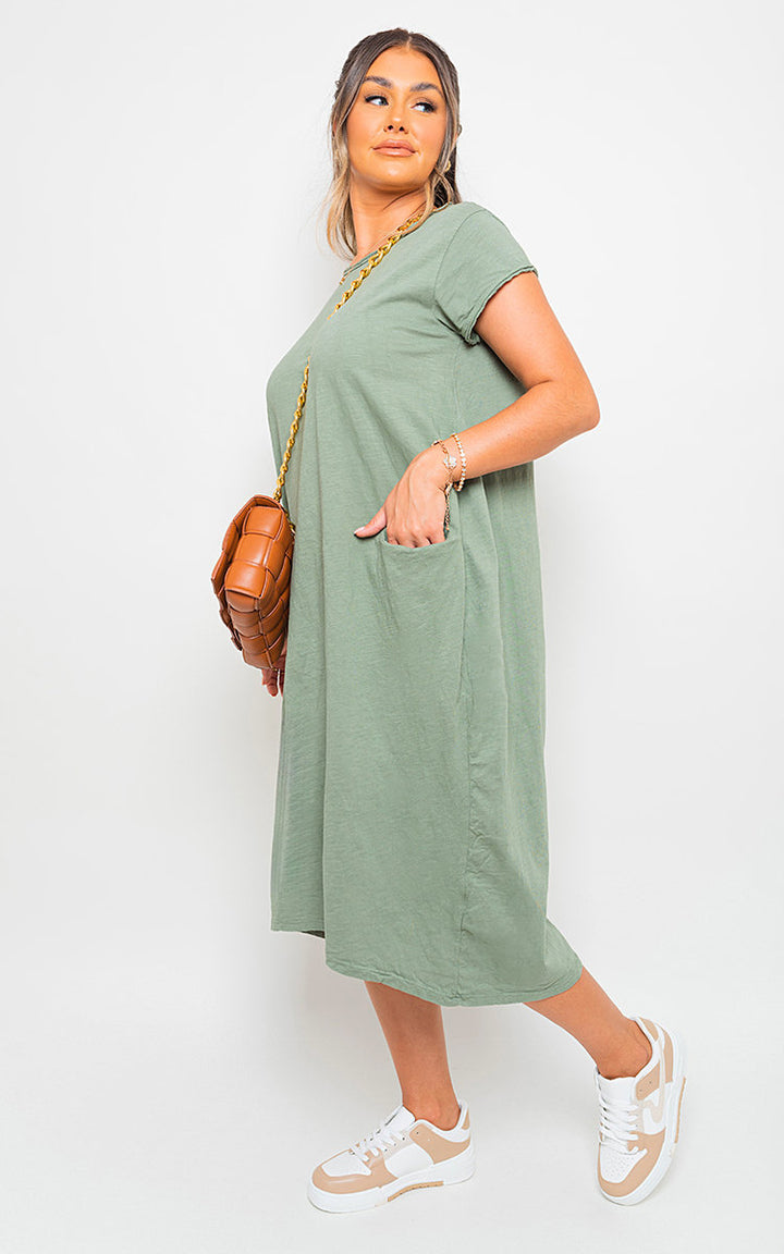 Front Pockets Short Sleeve Midi Dress worn by a woman, showcasing its chic silhouette and practical front pockets, ideal for versatile styling.