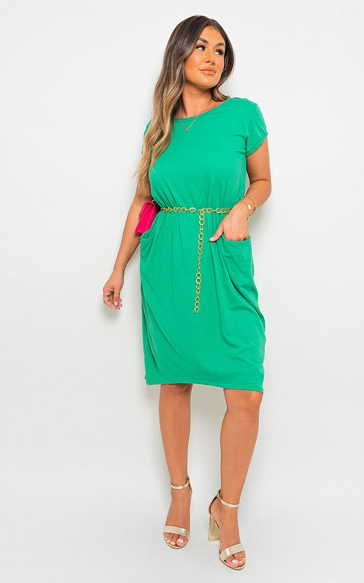 Woman in a green Front Pockets Short Sleeve Midi Dress with gold sandals, showcasing practicality and style for versatile occasions.