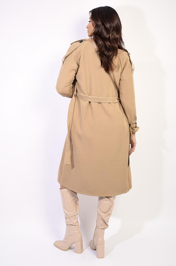 Woman wearing the Millie Waist Tie Button Detailed Trench Coat, showcasing its stylish silhouette and sophisticated button accents.