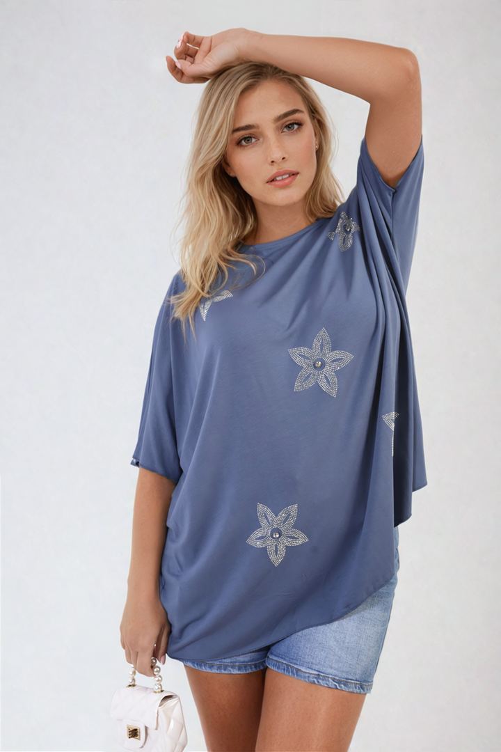 Woman models Nadia Floral Print Oversized Top, showcasing its relaxed fit and vibrant floral design, perfect for casual and stylish everyday wear.