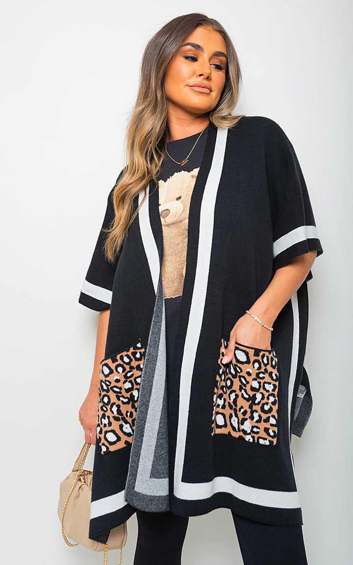 Woman wearing the Nadia Leopard Pocket Wrap Knitted Cardigan, showcasing its wrap design and leopard pocket detail, ideal for stylish comfort.