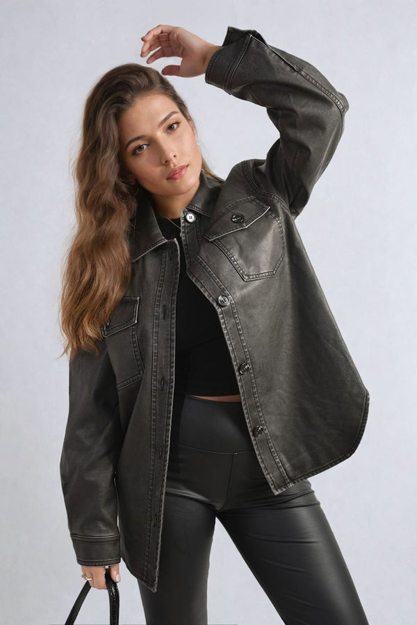 Woman wearing a Nancy Button Front Pocket Detail Faux Leather Jacket, showcasing its stylish design and practicality with button-up front and pockets.