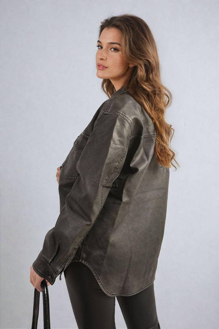 Woman wearing Nancy Button Front Pocket Detail Faux Leather Jacket, showcasing its trendy button-up design and practicality with pockets, perfect for casual outings.