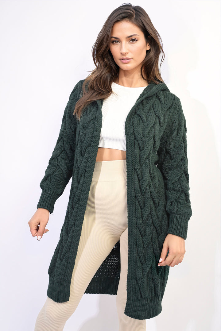 Woman wearing the Chunky Cable Knitted Oversized Longline Hooded Cardigan, showcasing its cozy, layered fit ideal for stylish comfort.