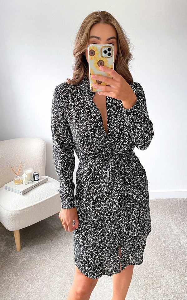 Woman taking a selfie in a Printed Mini Dress with a loose fit and v-neck, capturing the essence of stylish holiday fashion from Holiday Clothes UK.