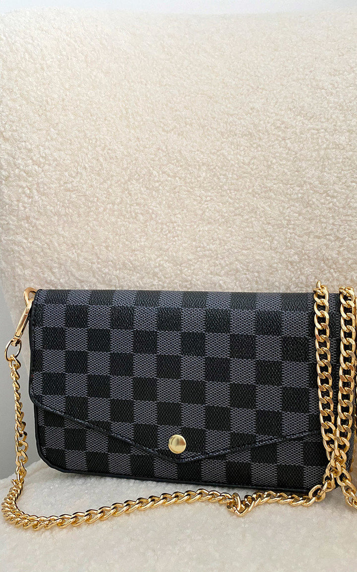 Check Print Clutch Bag featuring a black and gold checkered pattern, gold detachable chain, and button fastening, perfect for casual or chic styling.