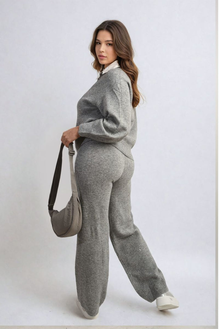 Woman in a grey Long Sleeve Knitted Collar Top and Wide Leg Pants Co-ord Set, holding a purse, showcasing effortless style and comfort.