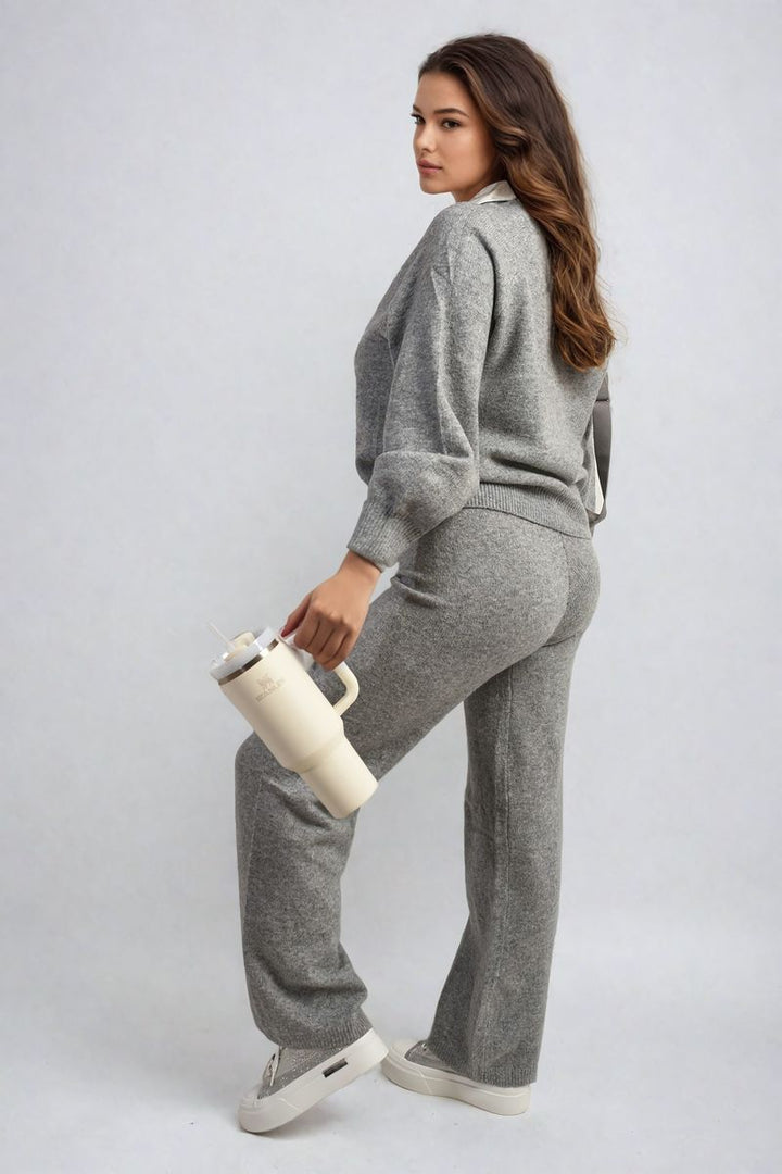 Woman wearing the Patricia Long Sleeve Knitted Collar Top and Wide Leg Pants Co-ord Set, holding a water bottle, showcasing stylish comfort and chic design.