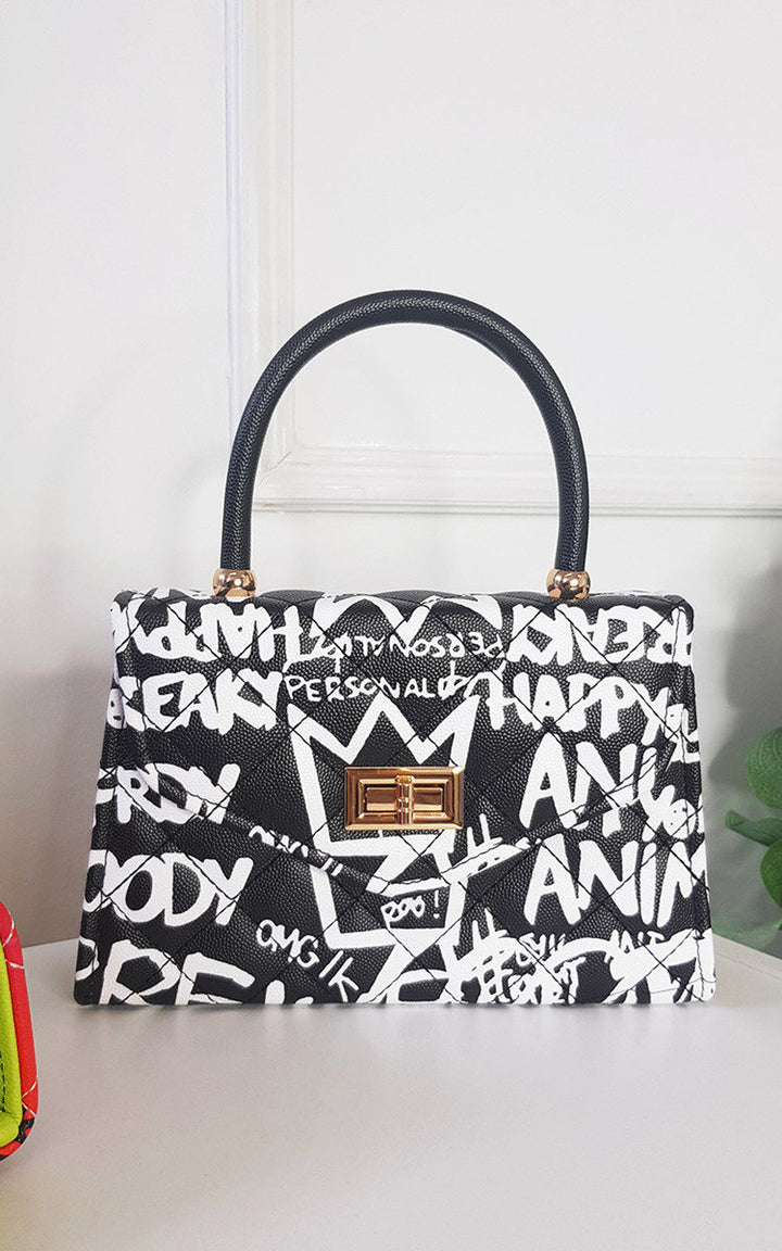 Graffiti Print Handbag with faux leather and clasp fastening, perfect for everyday style from Holiday Clothes UK.