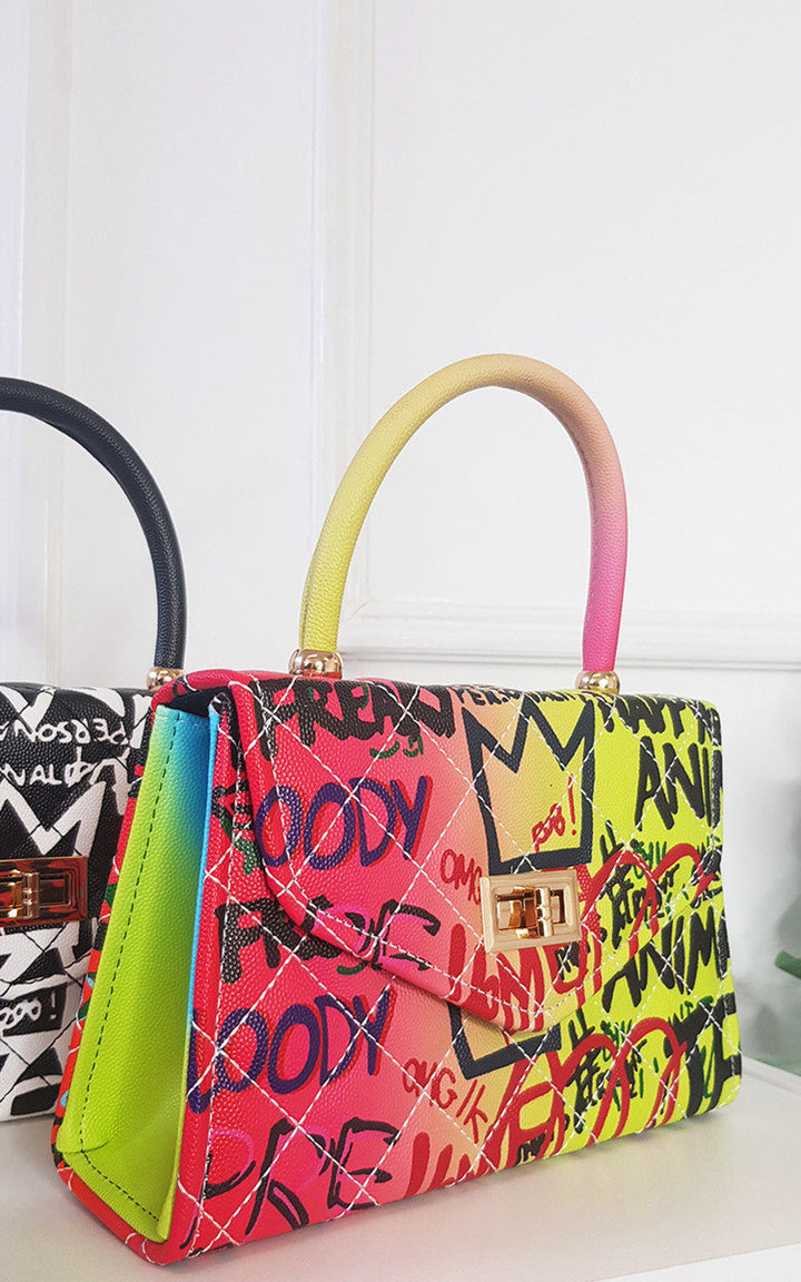 Graffiti Print Handbag with faux leather and clasp fastening, featuring vibrant graffiti design. Ideal for everyday use.