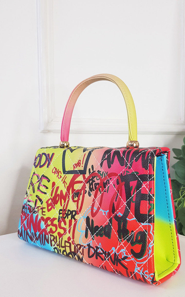 Graffiti Print Handbag with faux leather and clasp fastening, perfect for everyday wear from Holiday Clothes UK.