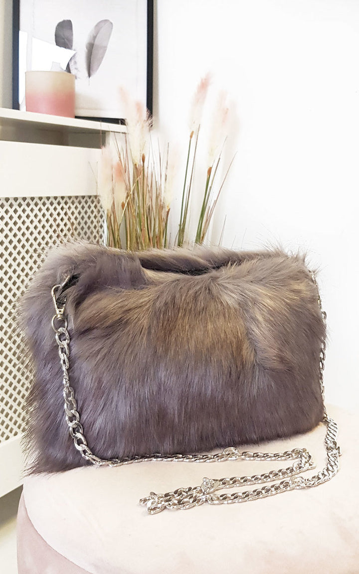 Faux Fur Shoulder Bag with detachable silver chain strap and fluffy texture, designed for casual styling with mom jeans and trainers.