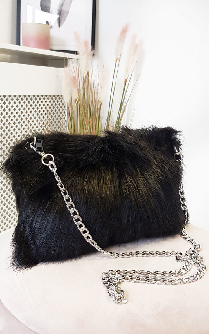 Faux Fur Shoulder Bag with silver chain strap, featuring a fluffy texture and zip closure, perfect for pairing with casual daytime outfits.