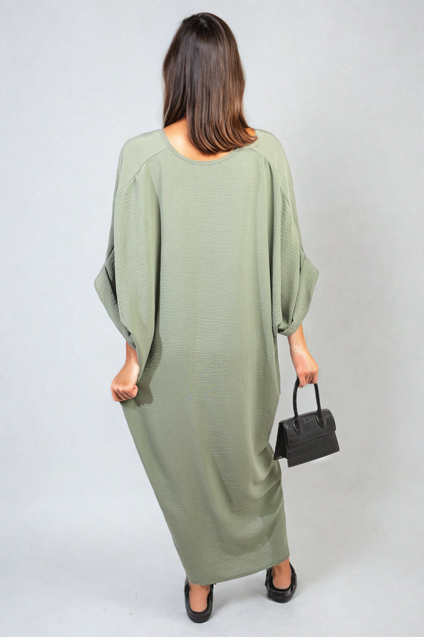 Twist Front Plunge Neckline Relaxed Fit Midi Dress showcased by a woman holding a black purse, highlighting the elegant and sophisticated design.