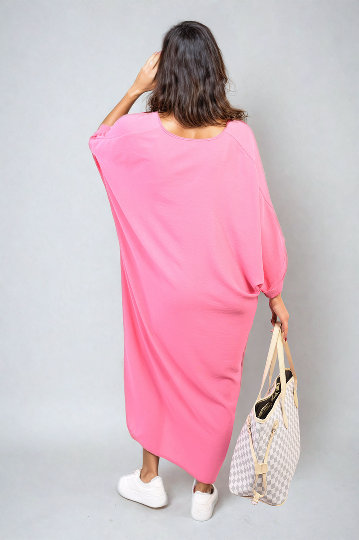 Woman in a pink Twist Front Plunge Neckline Relaxed Fit Midi Dress, holding a purse, showcasing elegant fashion for versatile styling.