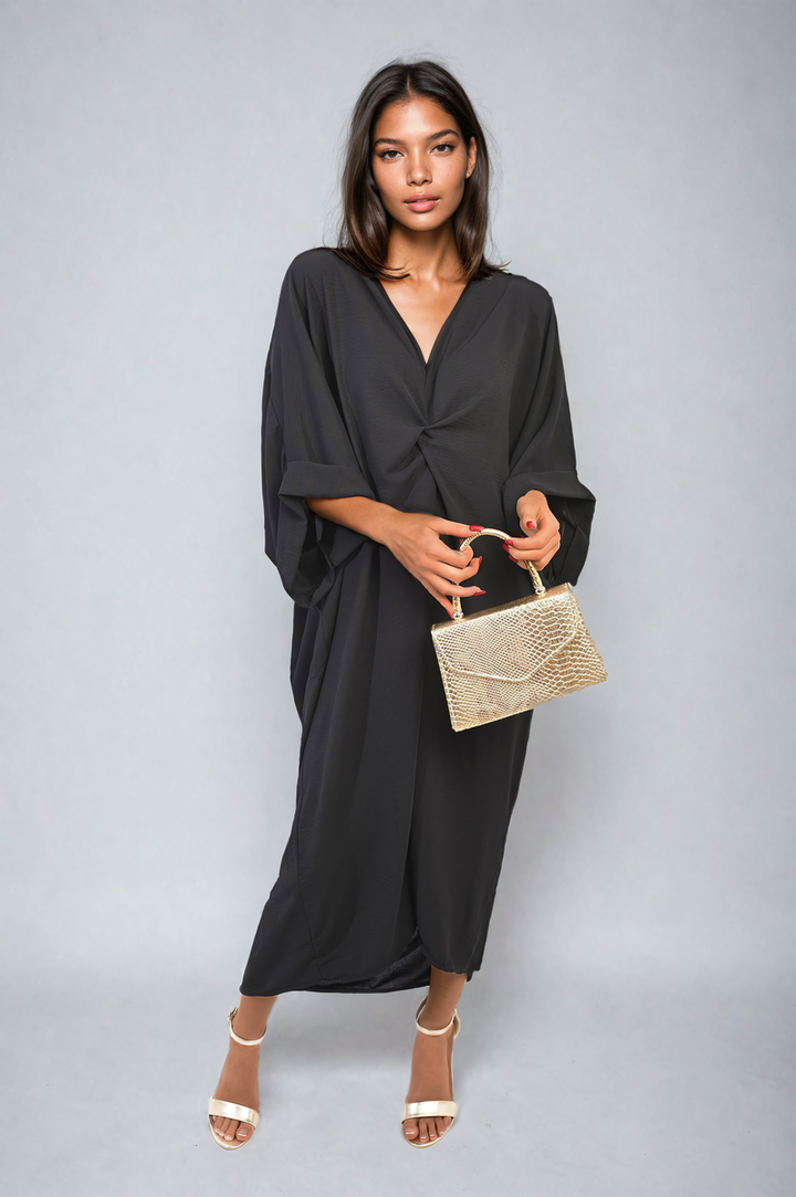 Woman in a black Twist Front Plunge Neckline Relaxed Fit Midi Dress holding a gold purse, showcasing elegant design and flattering silhouette.