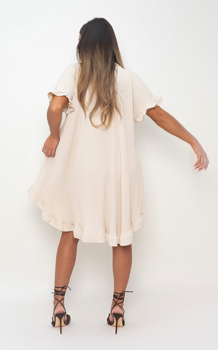 Woman wearing Button Down Oversized Ruffle Short Sleeve Mini Dress, showcasing its ruffle sleeves and button-down front, paired with brown sandals.