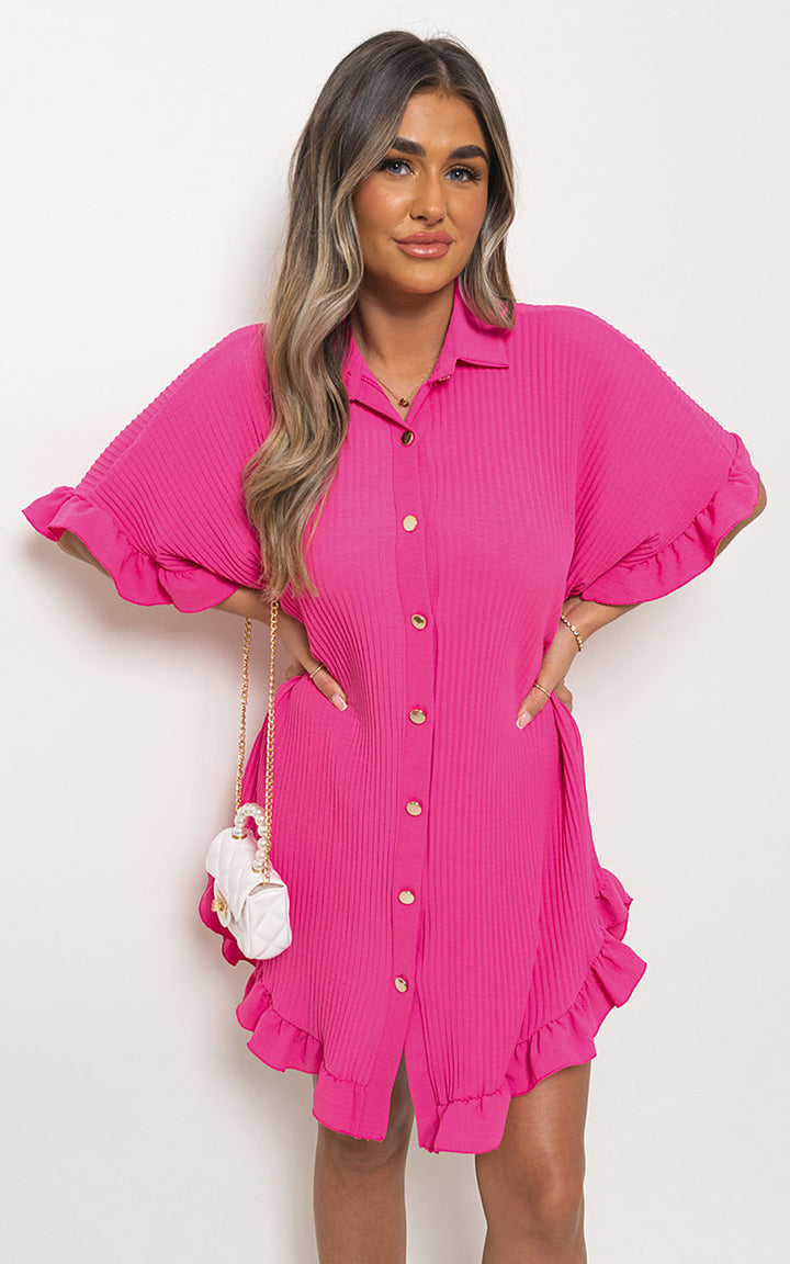 Woman wearing Button Down Oversized Ruffle Short Sleeve Mini Dress, showcasing its ruffle sleeves and button-down front, perfect for stylish, casual wear.