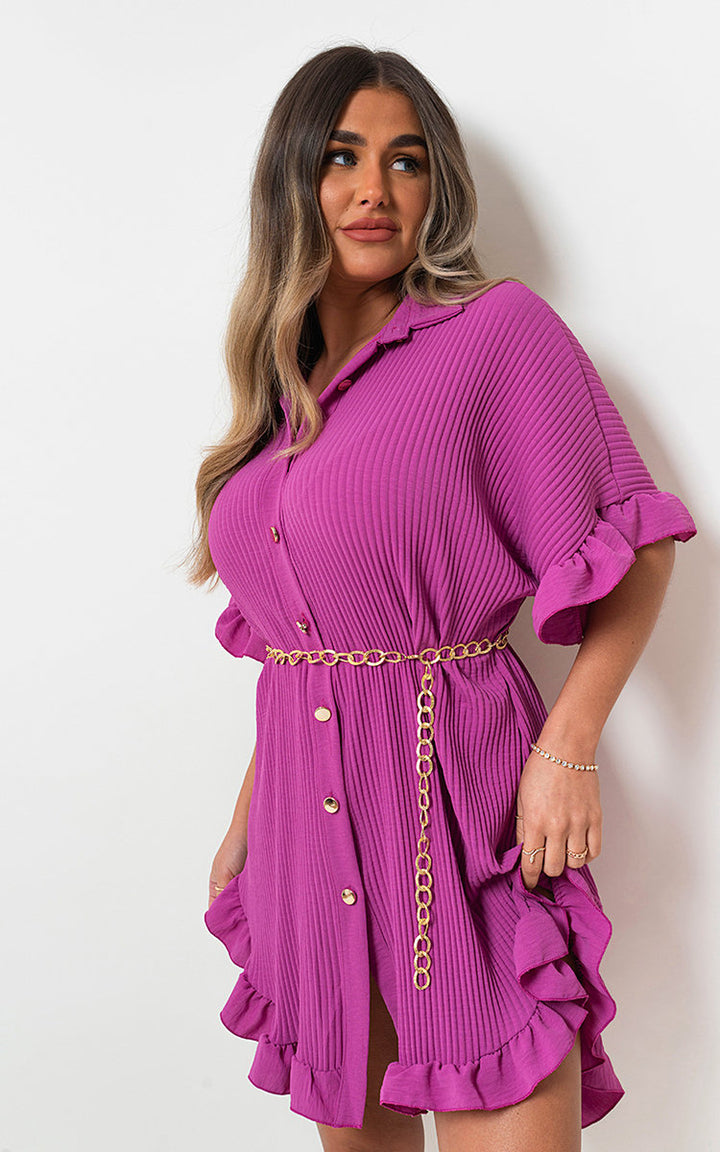 Woman wearing the Button Down Oversized Ruffle Short Sleeve Mini Dress, featuring ruffle sleeves and a button-down front, ideal for stylish holiday looks.