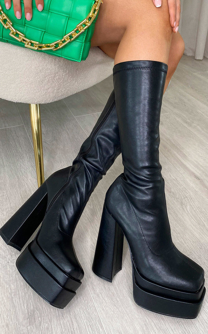 Block High Heel Boots with Zip Detail, featuring faux leather and a block heel for stability, perfect for any outfit. Ideal for stylish holiday or everyday wear.