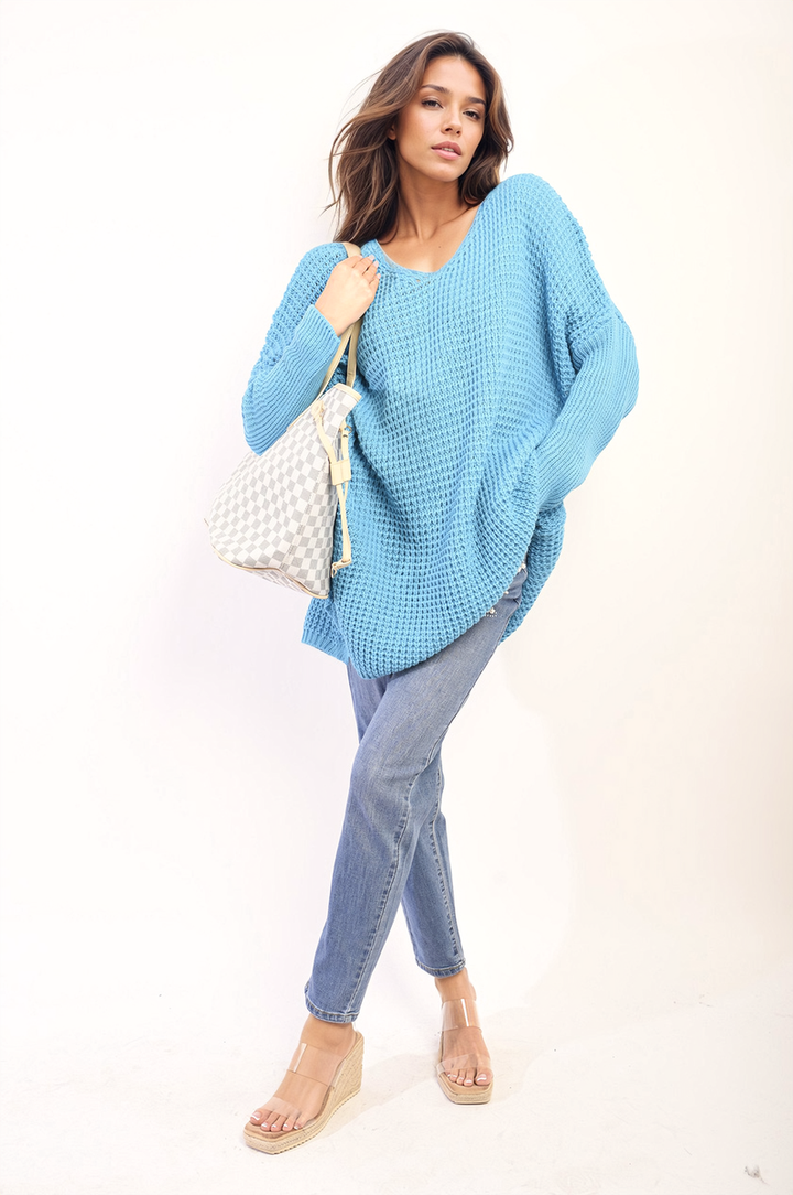 Woman wearing Oversized Chunky Knitted Jumper, styled with jeans, showcasing its relaxed, cozy fit for casual outings or home comfort.