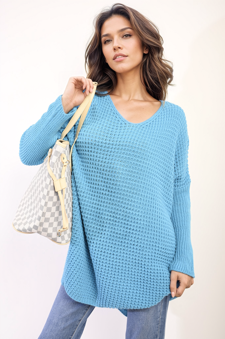 Woman holding an Oversized Chunky Knitted Jumper, showcasing its cozy, relaxed fit, ideal for casual outings or staying warm indoors.