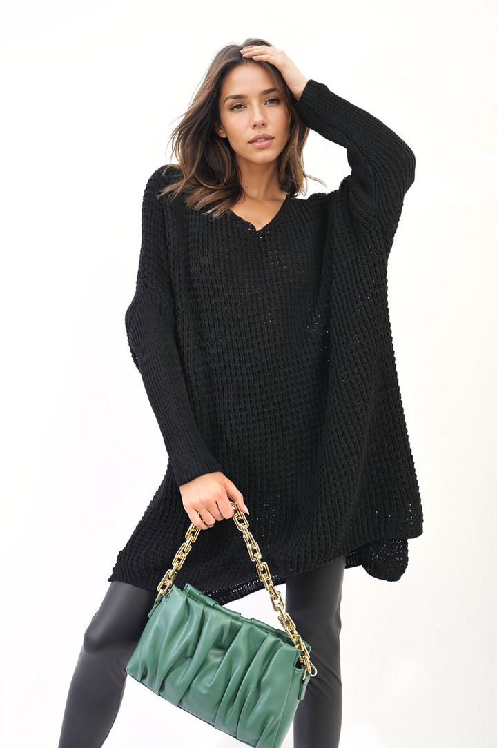 A woman models the Rebecca Oversized Chunky Knitted Jumper, showcasing its cozy and relaxed fit, perfect for casual outings or staying warm indoors.