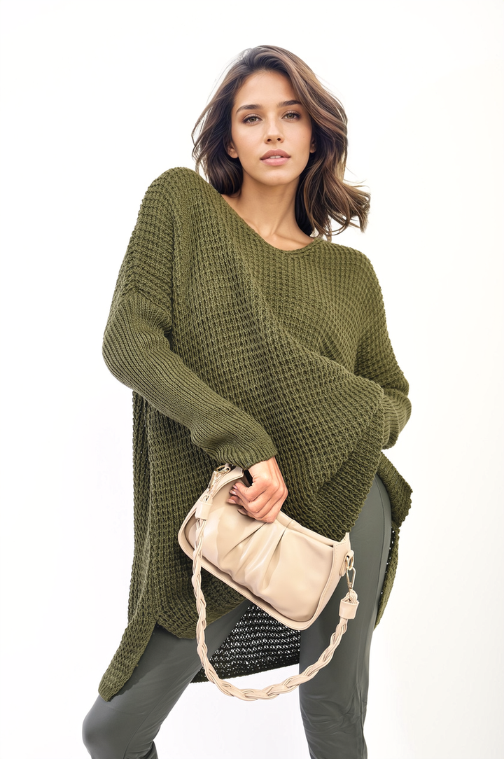 Woman holding a purse, showcasing the Rebecca Oversized Chunky Knitted Jumper, perfect for cozy and stylish winter wear.