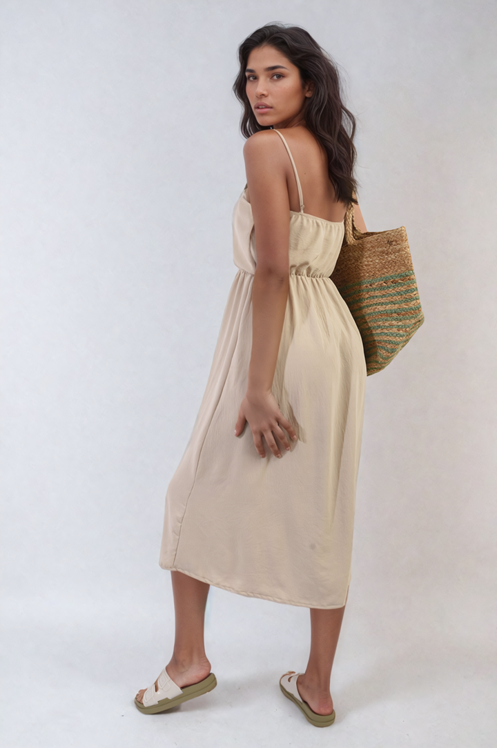 Woman wearing a Button Front Strappy Midi Dress, showcasing its elegant button detailing and trendy strappy design, perfect for stylish summer outings.