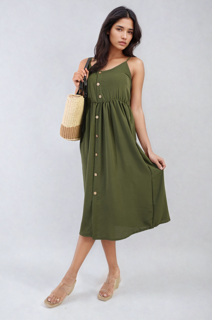 Woman wearing Button Front Strappy Midi Dress, holding a straw bag, showcasing trendy summer style in a lightweight, comfortable design. Ideal for versatile, stylish holiday outings.