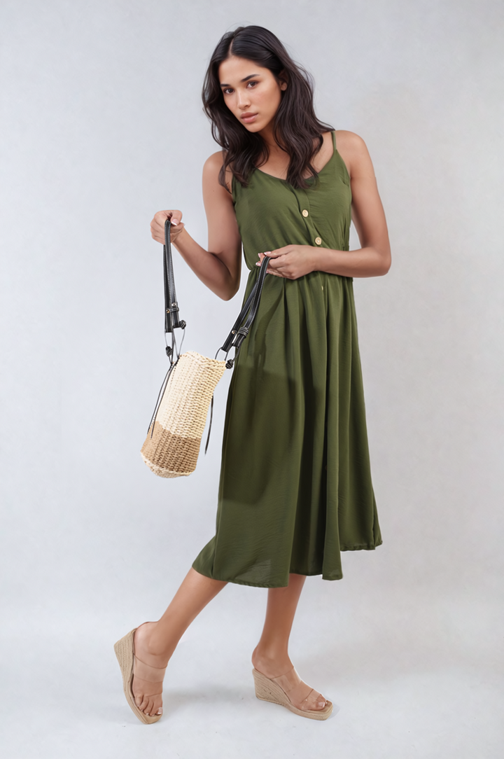 Woman in Button Front Strappy Midi Dress holding a woven bag, showcasing elegant summer fashion with a chic, strappy silhouette and button-front detail.