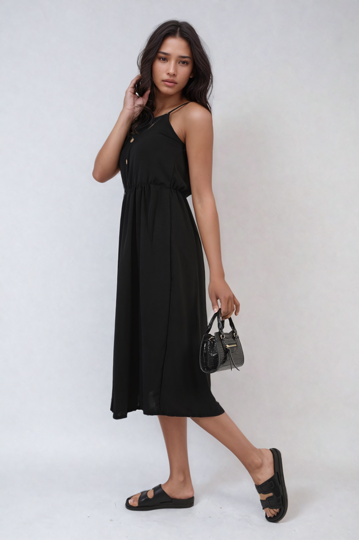 Woman in a Button Front Strappy Midi Dress holding a purse, showcasing a stylish, breezy look perfect for summer outings and holiday occasions.