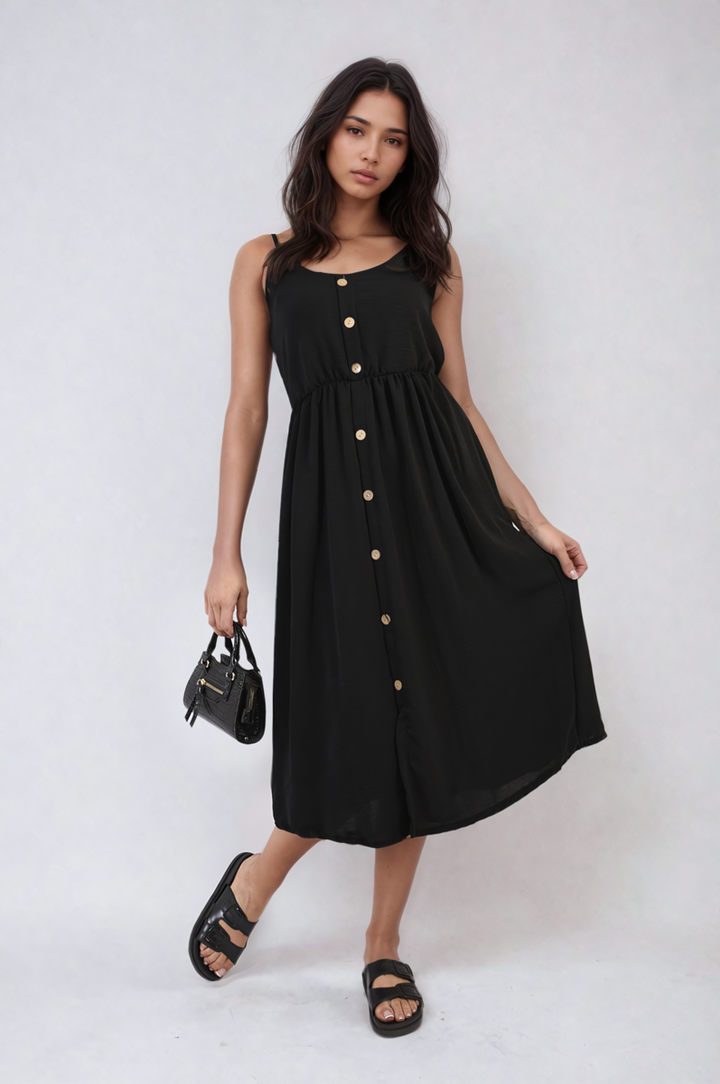 Button Front Strappy Midi Dress worn by a woman, complemented by black sandals and a purse, showcasing its chic, summery design and elegant button-front detail.