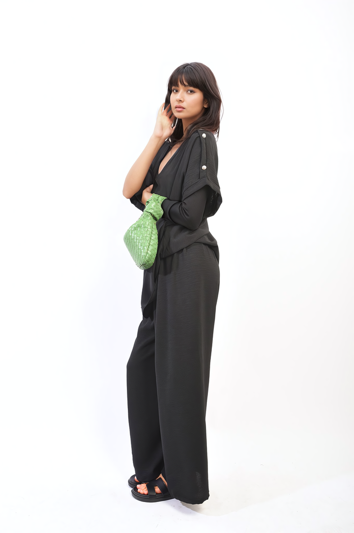 Woman in Riley Button Detail V Neck Loose Top and Wide Leg Trouser Co-ord Set, showcasing summer sophistication and effortless elegance.