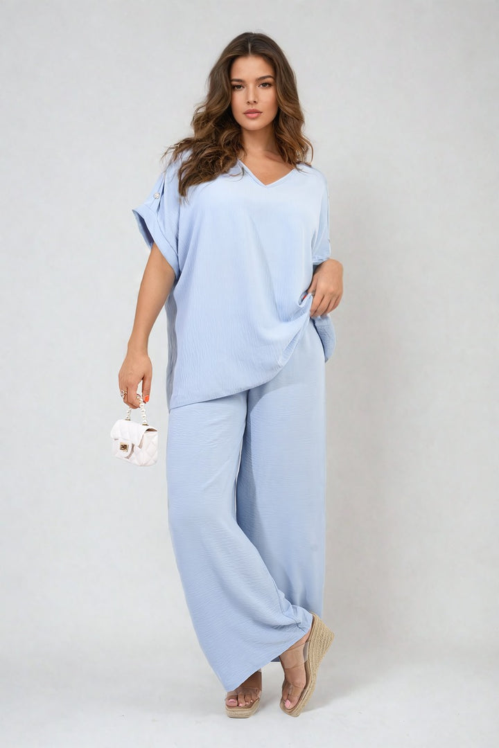 Woman wearing the Riley Button Detail V Neck Loose Top and Wide Leg Trouser Co-ord Set, showcasing its elegant design and comfortable fit.