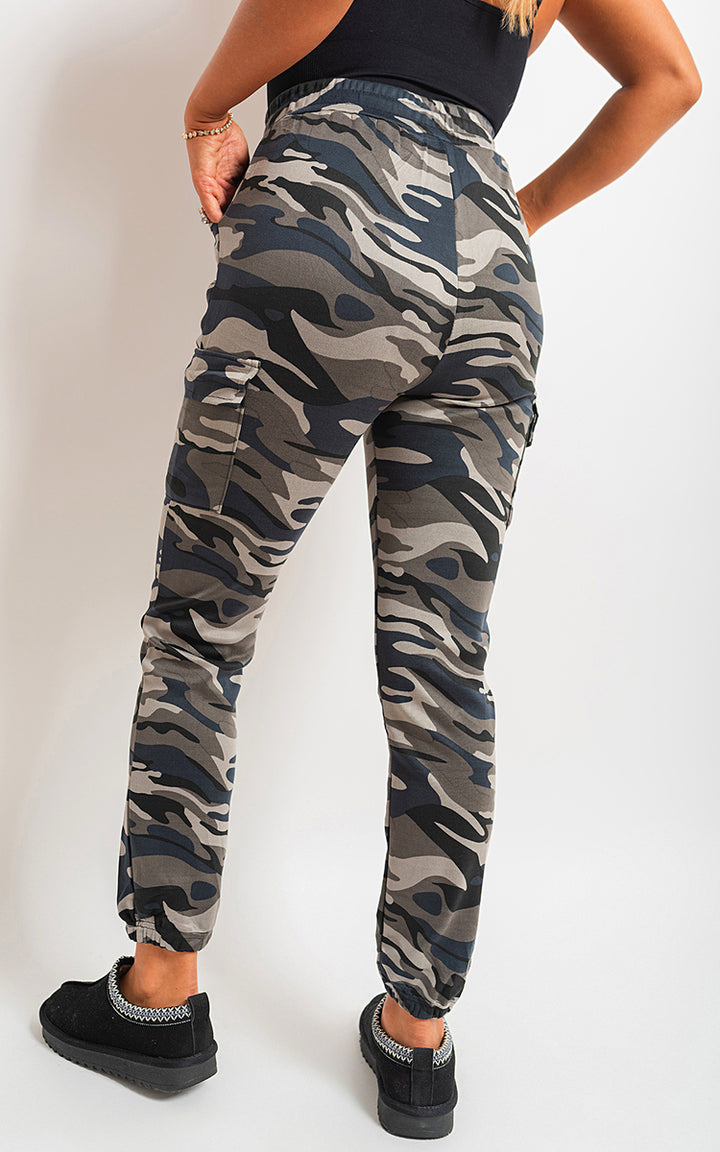 Camo Print Tie Cargo Trousers showcased on a woman, highlighting the trendy camo design and functional cargo pockets for a stylish, versatile look.