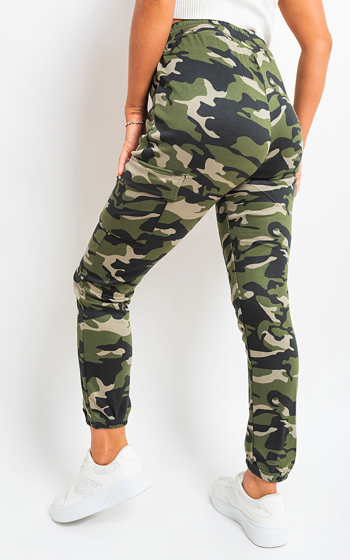 Woman wearing Robyn Camo Print Tie Cargo Trousers with tie waist and multiple cargo pockets, showcasing a stylish and functional look for casual wear.