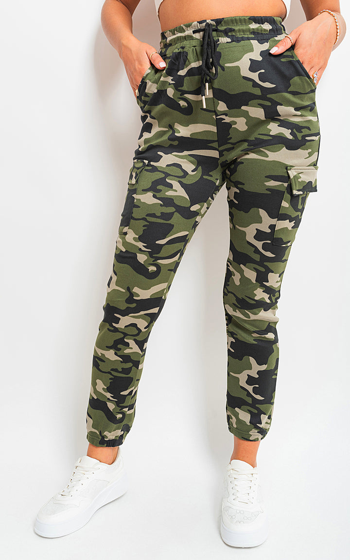 Woman wearing Robyn Camo Print Tie Cargo Trousers with tie waist and cargo pockets, showcasing a trendy, functional style from Holiday Clothes UK.