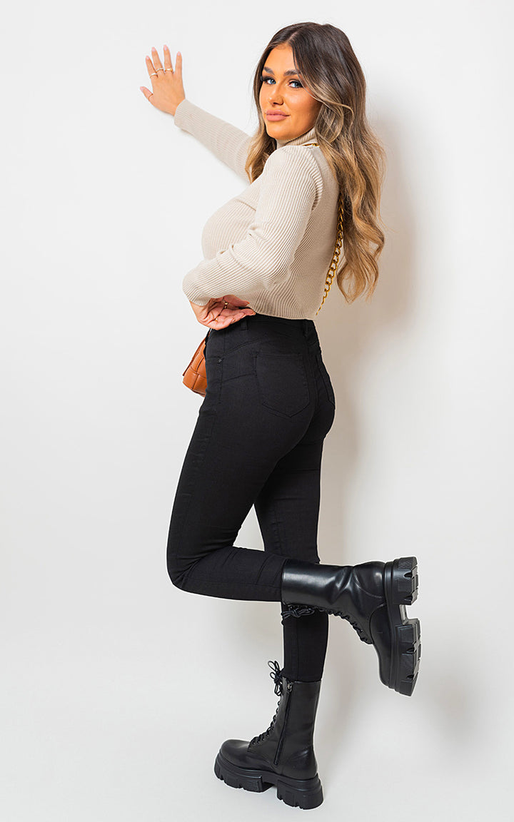 High Waisted Skinny Fit Jeans modeled by a woman, showcasing a flattering high-waisted design and sleek silhouette, perfect for stylish everyday wear.