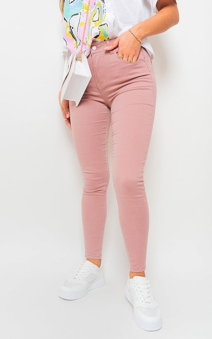 Woman wearing stylish High Waisted Skinny Fit Jeans, showcasing a flattering fit and modern design, paired with white sneakers for a casual look.