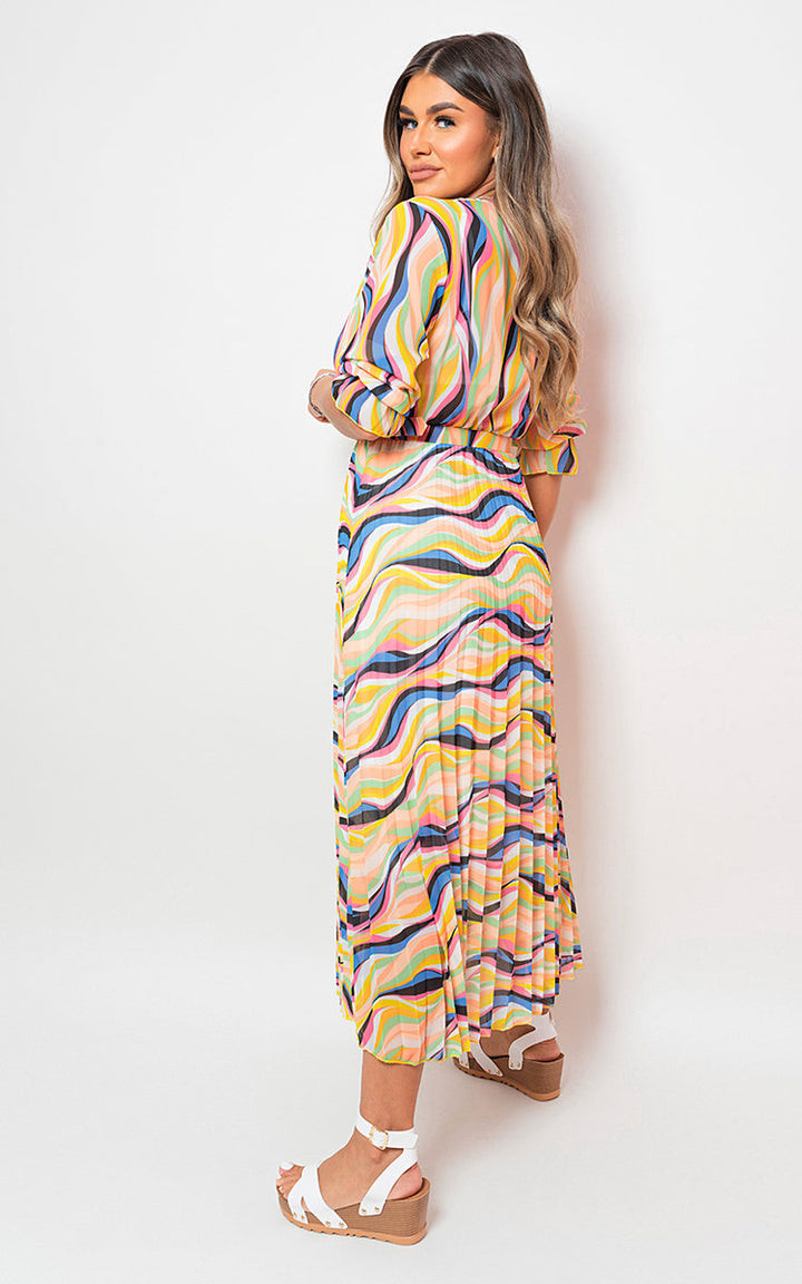 Woman wearing the Long Sleeve Printed Maxi Dress with Belt Detail, showcasing its stylish pattern and flattering fit, perfect for various occasions.