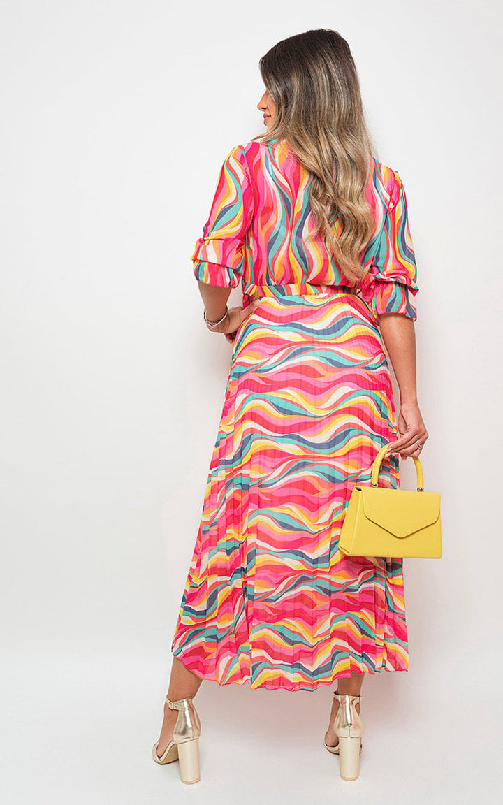 Woman in Long Sleeve Printed Maxi Dress with Belt Detail, holding a yellow bag, showcasing the dress's vibrant print and flattering fit. Perfect for any occasion.