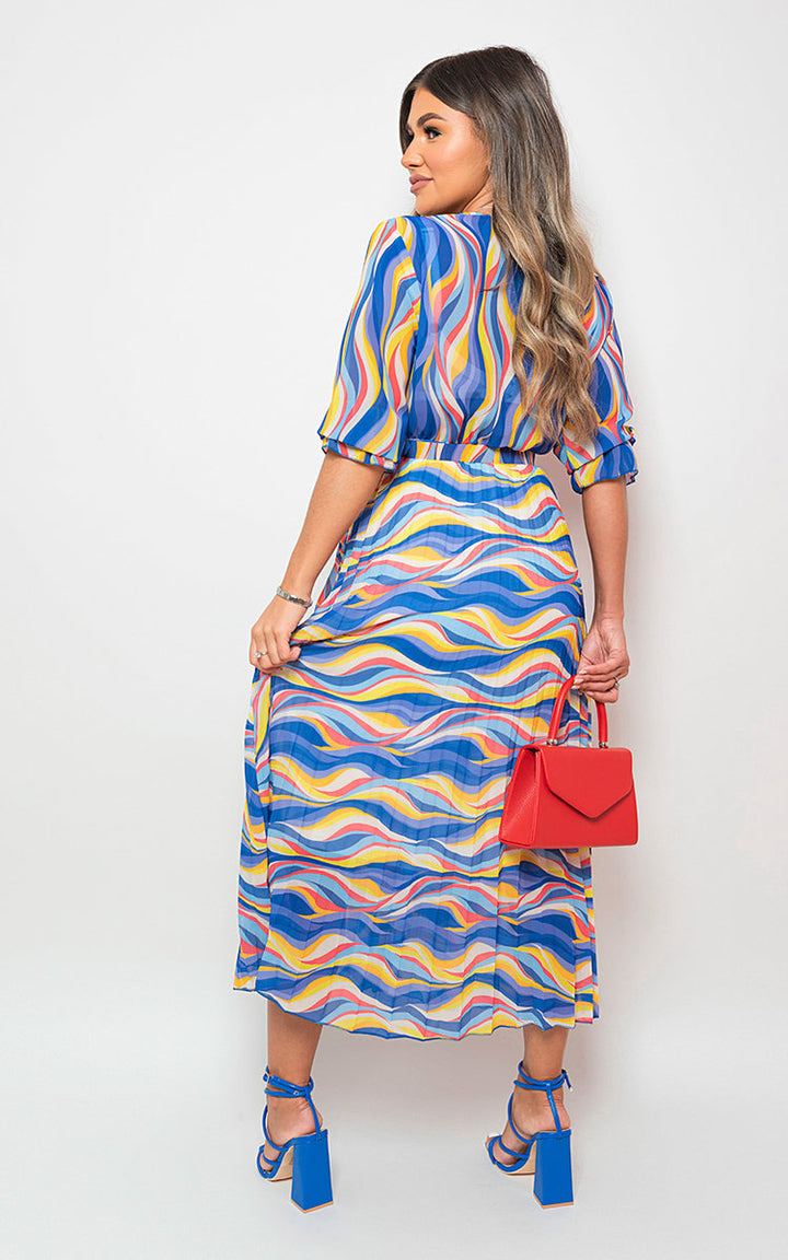 Woman wearing the Rosie Long Sleeve Printed Maxi Dress with Belt Detail, holding a red bag, showcasing a stylish and versatile design suitable for various occasions.