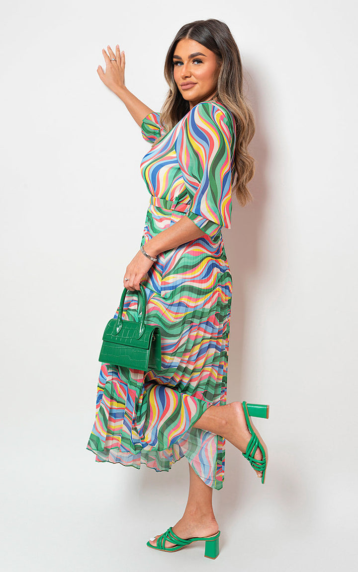 Woman wearing the Long Sleeve Printed Maxi Dress with Belt Detail, showcasing its vibrant print and elegant design, ideal for stylish holiday occasions.