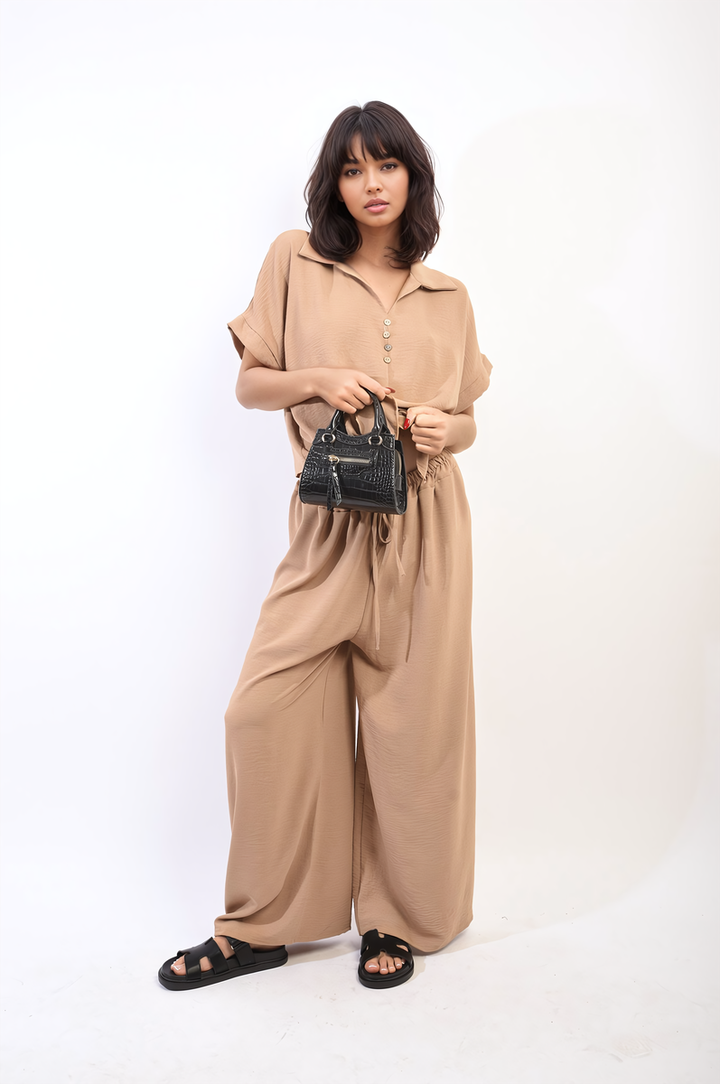 Woman in Tie Front Top and Wide Leg Pants Co-ord Set, showcasing relaxed fit and modern design. Holding a black purse, wearing black sandals.